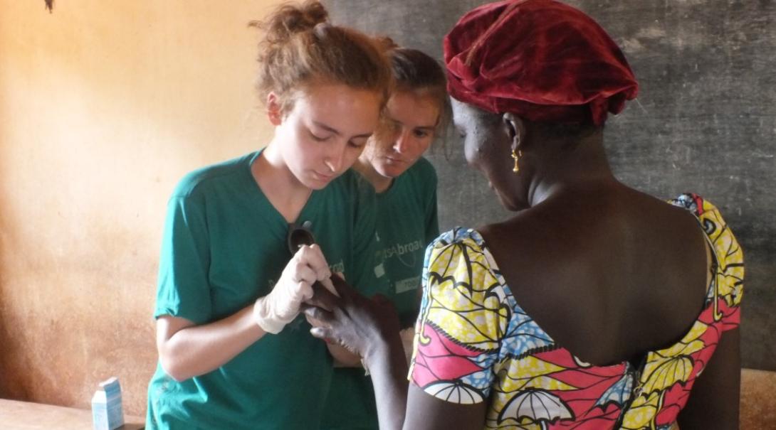 A nursing student examines a patient in Togo A nursing student examines a patient in Togo